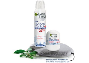 Antyperspirant Garnier Mineral Action Control+ w sprayu i kulce na kamieniu, obok zieleń