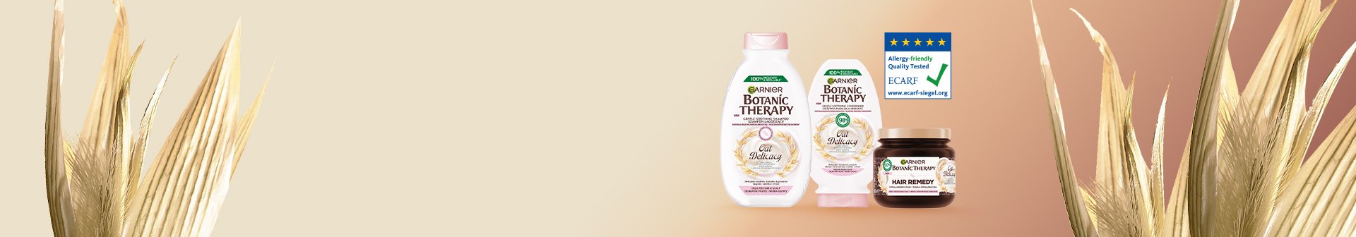 Trzy produkty Garnier Botanic Therapy Oat Delicacy na gradiencie beżowo-różowym, obok suche liście