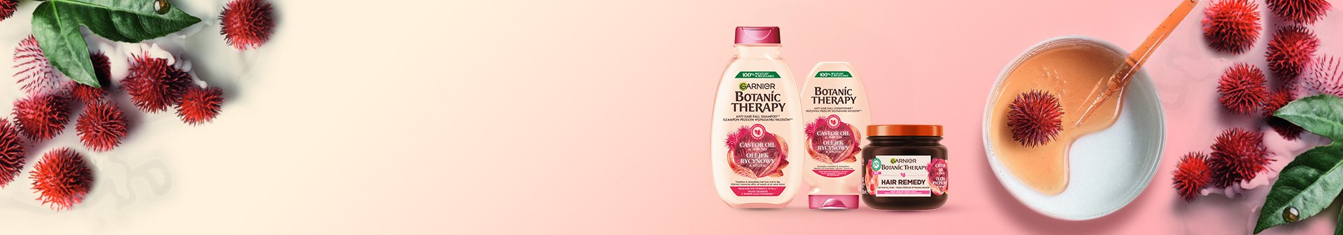 Produkty Garnier Botanic Therapy wśród czerwonych owoców i zielonych liści, na różowo-kremowym tle