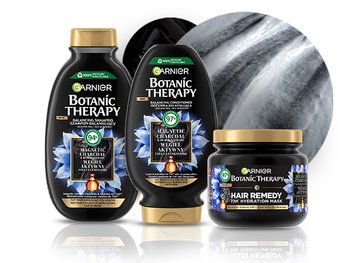 Trzy czarno-złote produkty Garnier Botanic Therapy (szampon, odżywka, maska) z odbiciem, motyw kwiatów