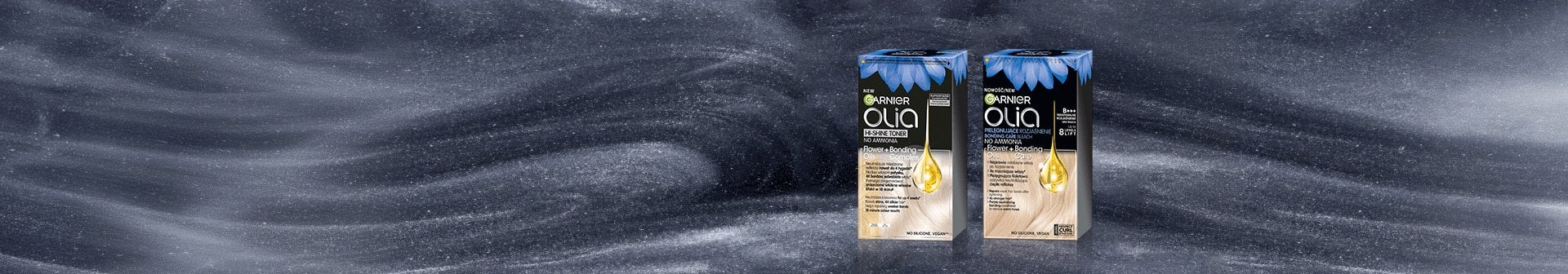 Dwa opakowania Garnier Olia Hi-Shine Toner na ciemnoszarej, falistej powierzchni