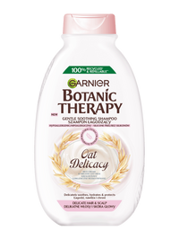 Biała butelka szamponu Garnier Botanic Therapy Oat Delicacy z motywem owsa, na białym tle