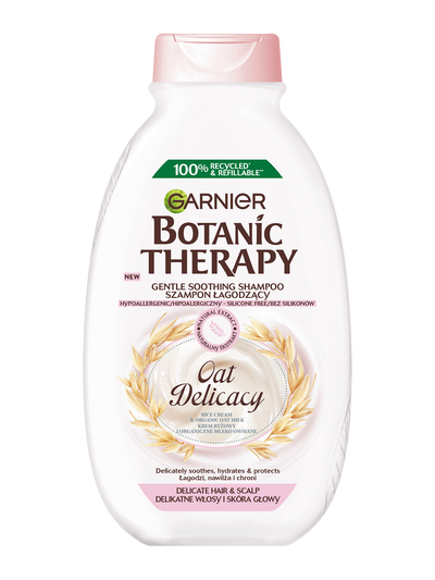 Biała butelka szamponu Garnier Botanic Therapy Oat Delicacy z motywem owsa, na białym tle