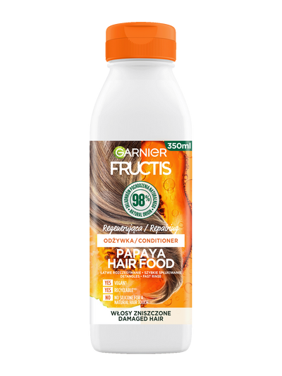Biała butelka odżywki Garnier Fructis Papaya Hair Food z pomarańczowym kapslem, na białym tle