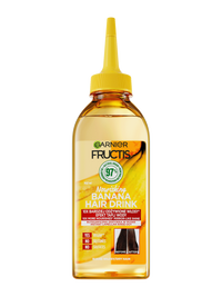 Butelka Garnier Fructis z bursztynowym płynem i żółtym dziubkiem, napis „97% naturalnych składników”