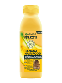 Żółta butelka szamponu Garnier Fructis Banana Hair Food, na czarnym tle