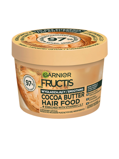 Jasnobrązowy, okrągły słoik Garnier Fructis Cocoa Butter Hair Food, pod skosem, na białym tle