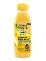 Żółta butelka szamponu Garnier Fructis Banana Hair Food, na czarnym tle