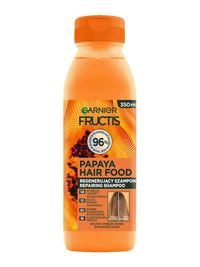 Pomarańczowa butelka szamponu Garnier Fructis Papaya Hair Food, na jasnym tle