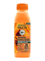 Pomarańczowa butelka szamponu Garnier Fructis Papaya Hair Food, na jasnym tle