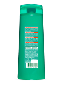 Turkusowa butelka szamponu Garnier, tylna etykieta z opisem produktu, na białym tle