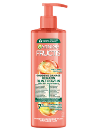 Różowo-pomarańczowa butelka Garnier Fructis z pompką i grafiką oleju marula, na różowym tle