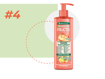 Różowa butelka Garnier Fructis z pompką na jasnozielonym tle z białym okręgiem