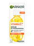 Buteleczka serum Garnier Vitamin C+ z pipetą, żółtym płynem, plasterkami cytrusów i pęcherzykami, na białym tle
