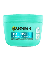 Turkusowy słoik kremu Garnier z grafiką kapsułki, na czarnym tle