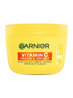 Żółty, okrągły słoik kremu Garnier Vitamin C Fresh & Bright, na czarnym tle