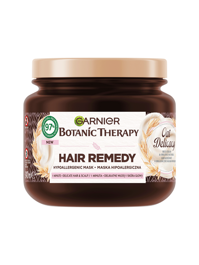 Ciemnobrązowy słoik maski Garnier Botanic Therapy Oat Delicacy ze złotą pokrywką, motyw owsa