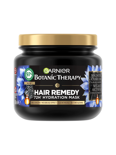 Czarny słoik maski Garnier Botanic Therapy ze złotą pokrywką, niebieskie kwiaty, węgiel i krople olejku