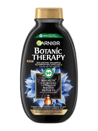 Czarna butelka szamponu Garnier Botanic Therapy z niebieskimi kwiatami i teksturą węgla