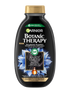 Czarna butelka szamponu Garnier Botanic Therapy z niebieskimi kwiatami i teksturą węgla