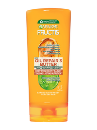 Pomarańczowa butelka wzmacniającej odżywki Garnier Fructis z etykietą, na białym tle