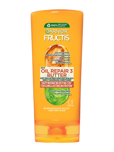 Pomarańczowa butelka wzmacniającej odżywki Garnier Fructis z etykietą, na białym tle