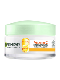 Biały słoik kremu Garnier Skin Naturals z jasnozieloną pokrywką, na jasnym tle