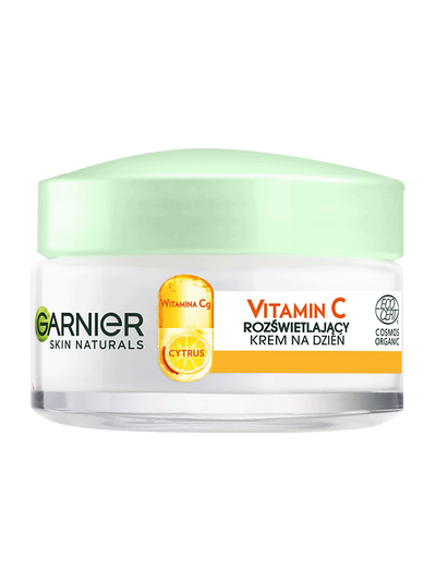 Biały słoik kremu Garnier Skin Naturals z jasnozieloną pokrywką, na jasnym tle
