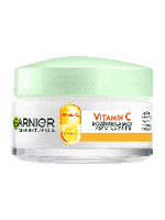 Biały słoik kremu Garnier Skin Naturals z jasnozieloną pokrywką, na jasnym tle