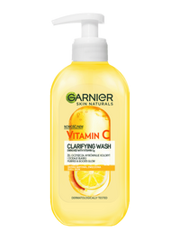 Żółta butelka Garnier Vitamin C Clarifying Wash z białą pompką i motywem cytrusów
