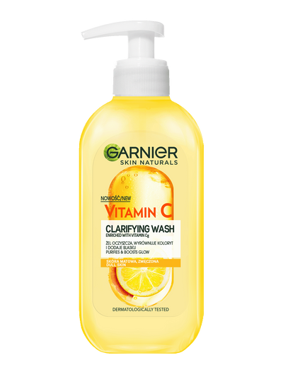 Żółta butelka Garnier Vitamin C Clarifying Wash z białą pompką i motywem cytrusów